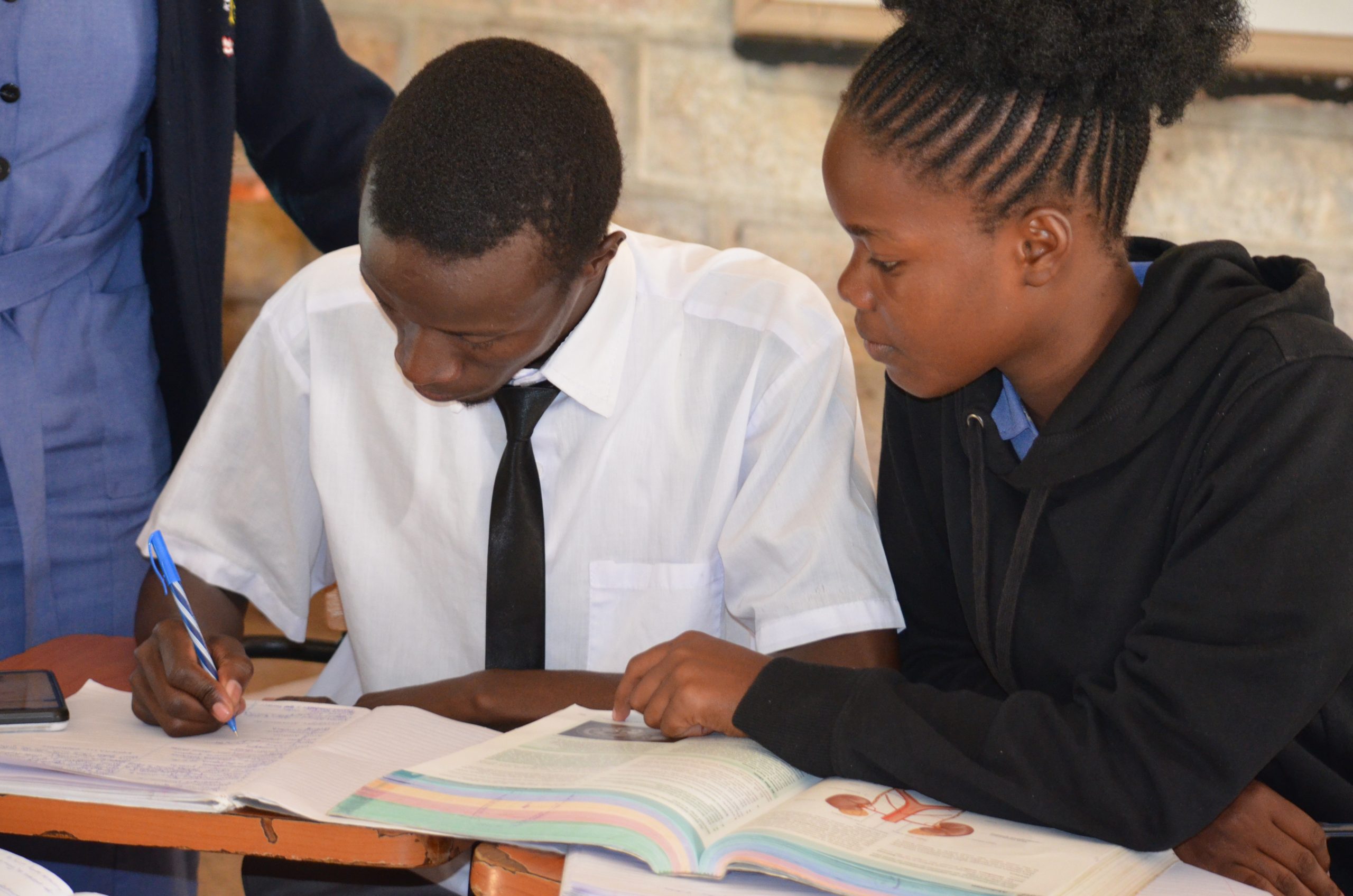 KASMS students studying together from a clinical textbook