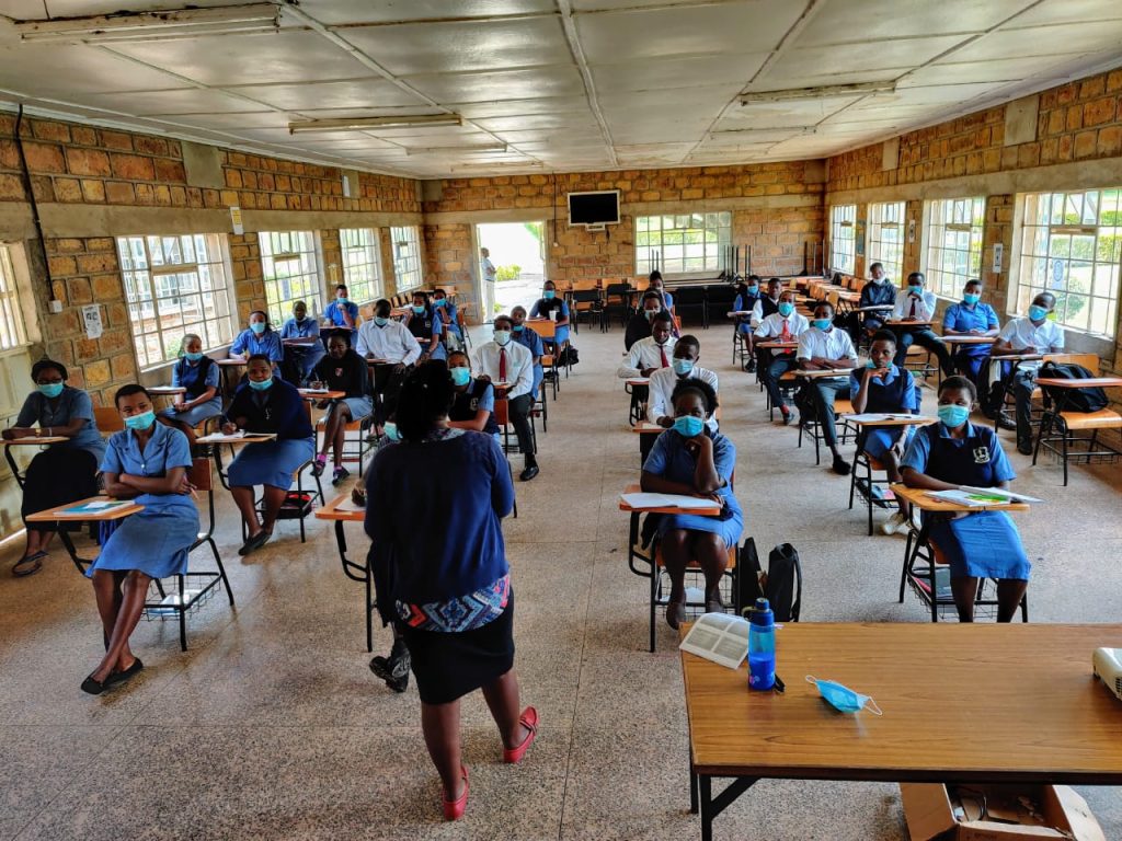 A KASMS lecture in a stone-walled classroom